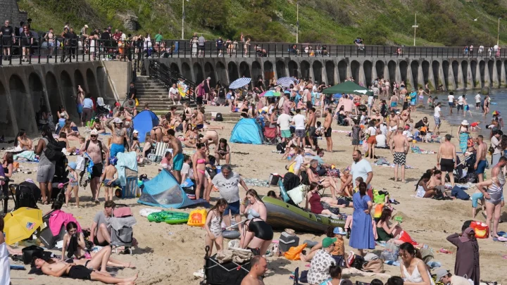 UK heatwave officially declared as temperatures top 32C on hottest day of the year so far