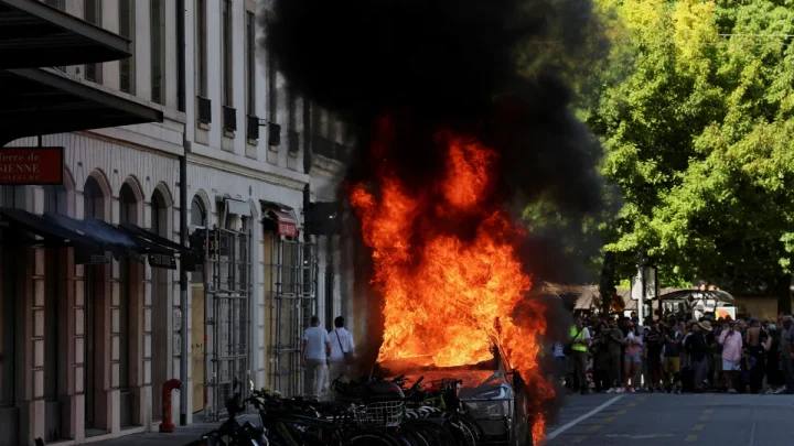 G7 protesters smash windows and set Tesla on fire as they march in Geneva