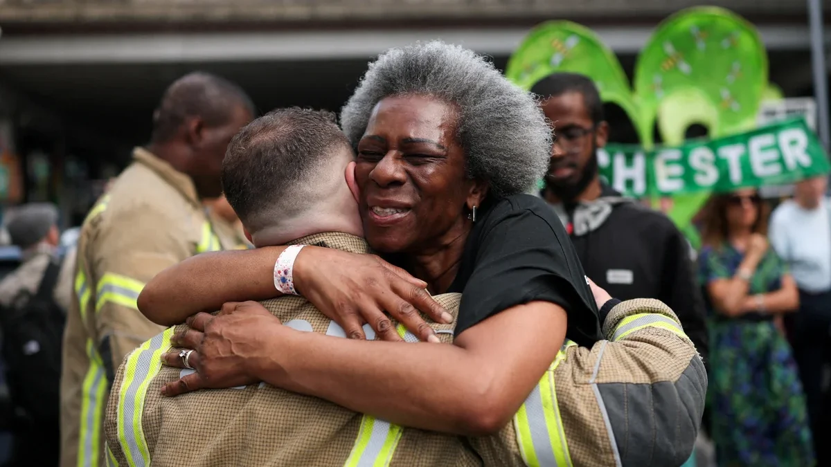 Grenfell survivors embrace firefighters at emotional anniversary march