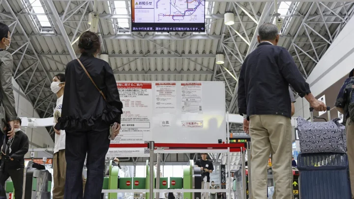 Heavy rain pounds western Japan as 2 tropical storms approach