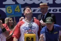 Joey Chestnut easily outpaces Nathan’s hot dog eating contest field but falls short of his own record in 100-degree heat